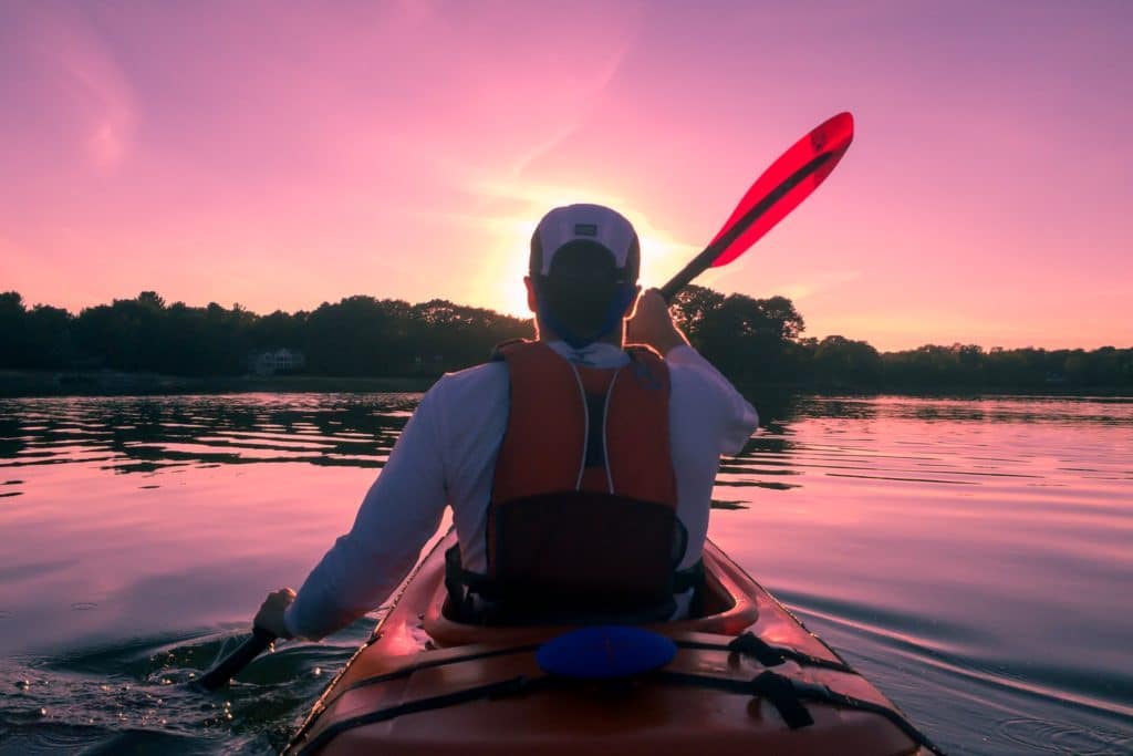 Man kayaking during sunset at Cherry Creek State Park